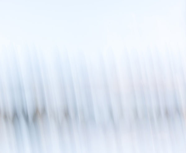 Minimalist abstract fine art photography print of soft diagonal light streaks in pale blue and white tones