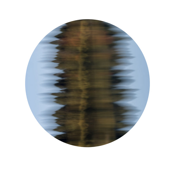 Circular abstract wall art print of rippling water reflections in golden amber and soft blue tones