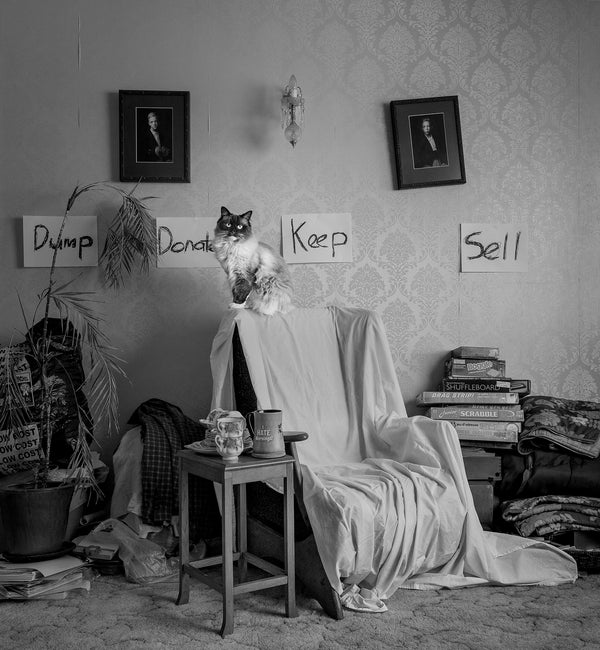 The Decision Maker, black and white fine art photography print, cat presiding over vintage room with Dump Donate Keep Sell signs, Michelle Fey, NZIPP Gold Award