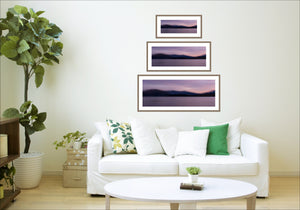 Echoes of Dusk fine art print by Michelle Fey shown in three sizes above a sofa - small, medium and large Lake Wanaka landscape photography using Intentional Camera Movement