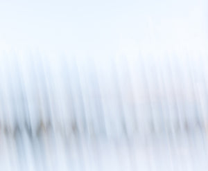 Minimalist abstract fine art photography print of soft diagonal light streaks in pale blue and white tones