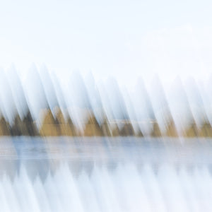 Abstract fine art photography print of trees and water reflections with soft diagonal light streaks in white, blue and golden tones