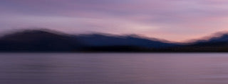 Fine art photography print of a moody purple and blue twilight over Lake Wanaka mountains created with intentional camera movement