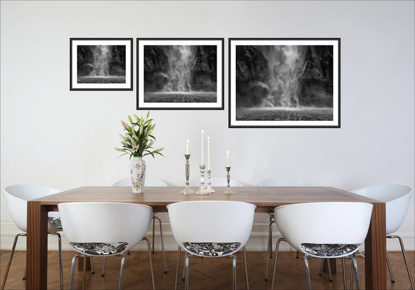 Echoes of the Falls black and white Milford Sound waterfall photography print displayed in three sizes in a dining room