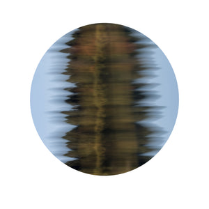 Circular abstract wall art print of rippling water reflections in golden amber and soft blue tones