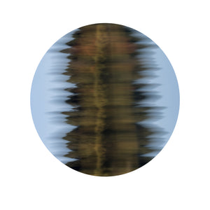 Circular abstract wall art print of rippling water reflections in golden amber and soft blue tones