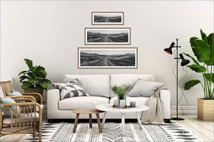 The Long Way Home black and white New Zealand road photography print displayed in all sizes in a lounge